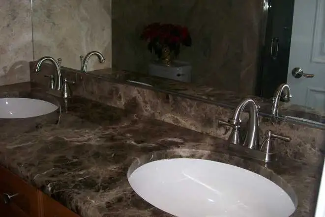 Dark brown marble vanity top with two undermount sinks
