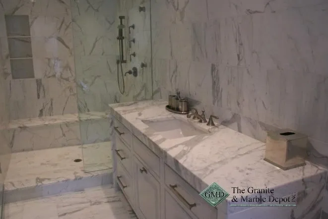White marble vanity top and marble-lined shower