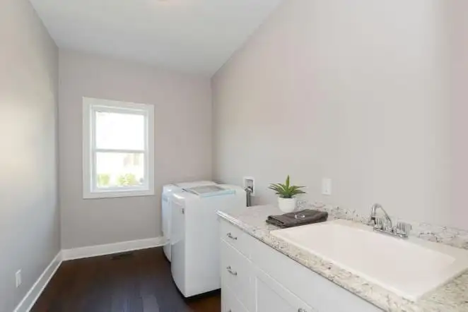 White vanity and tub in a bathroom under a sloped ceiling