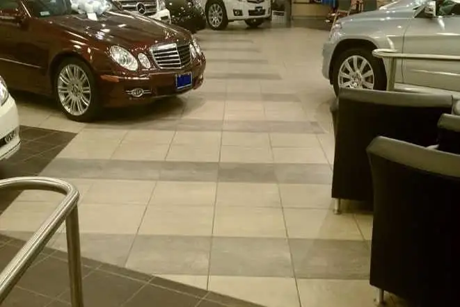 Car dealership showroom with a large-format tile floor