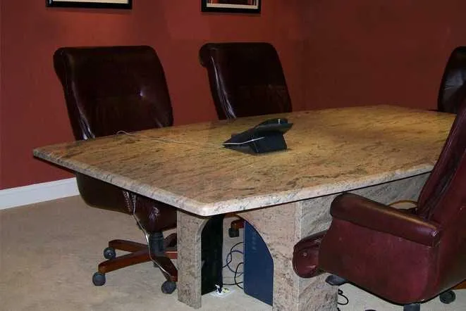 Granite-topped conference table with high-back chairs