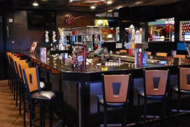 Restaurant bar with a polished granite top and bar stools