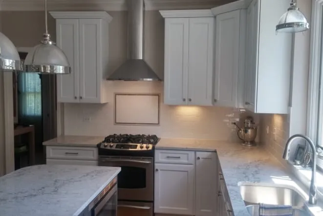 Calacatta-style quartz counters with an undermount sink in a white kitchen