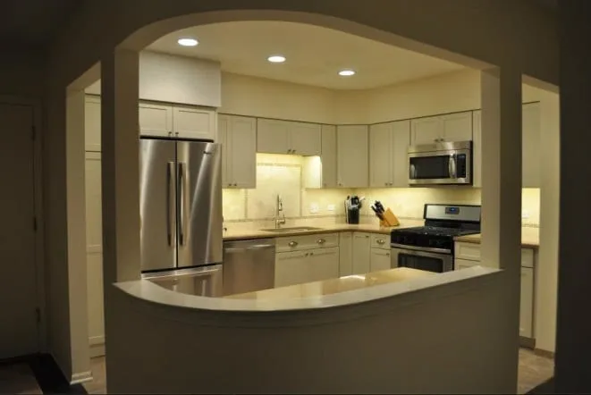 Curved white stone counter framed by an arched wall opening