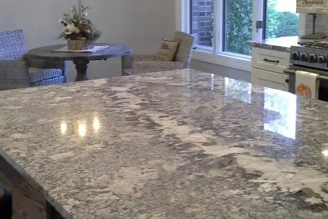 Close view of a polished grey and white granite island top