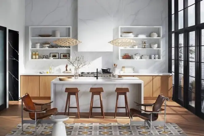 Modern kitchen with a full marble slab wall and a light wood island