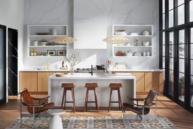Modern kitchen with a full marble slab wall and a light wood island