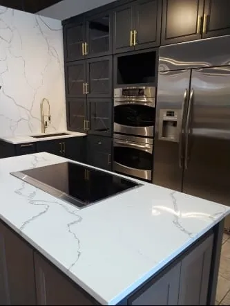 Boldly veined white quartz counters against black cabinetry