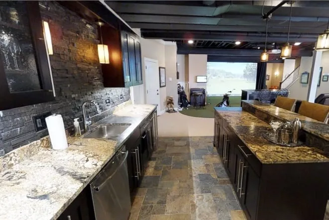 Entertaining bar with gold granite counters and a slate floor